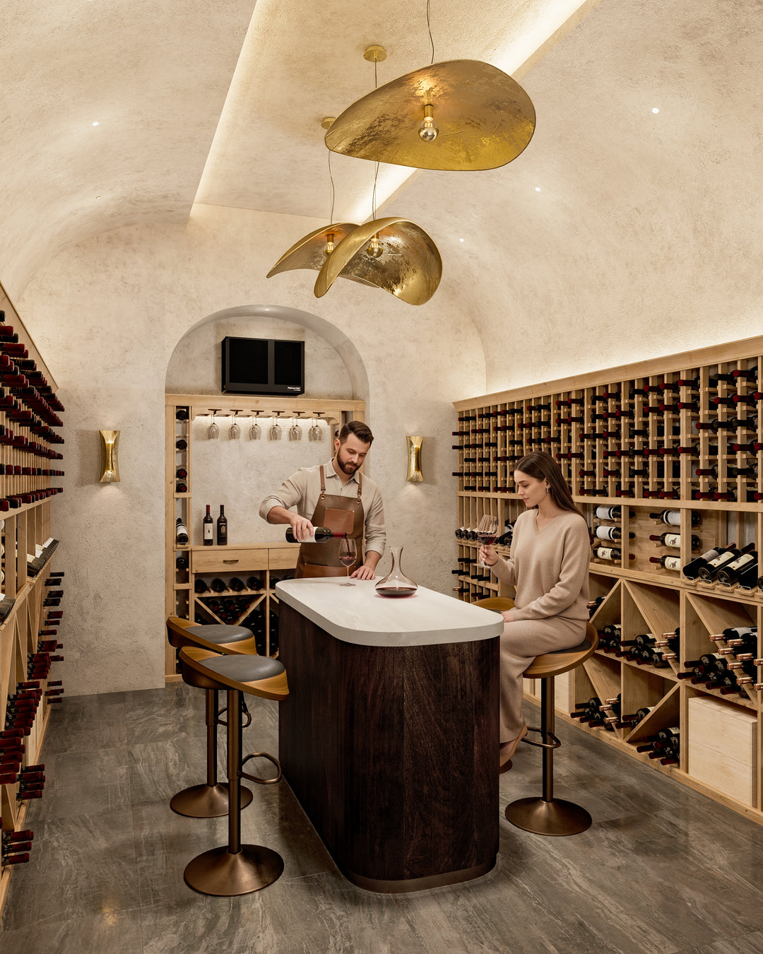 two people in a wine cellar enjoying wine. Wood wine cellar and cooling unit in the background.