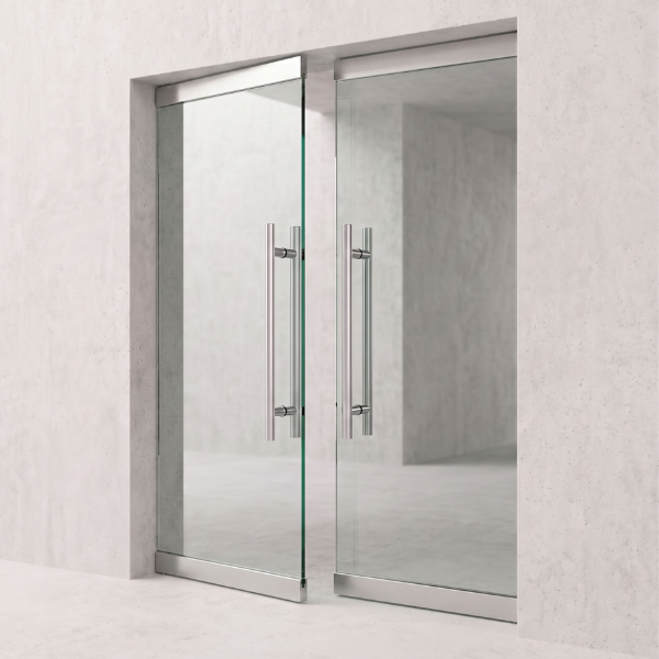 Framed wine cellar glass door with metallic handles on a light gray wall background