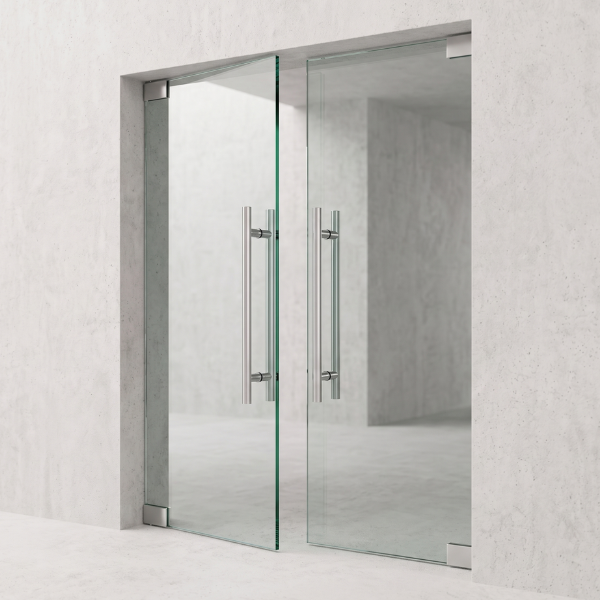 Frameless wine cellar glass door with metallic handles on a light gray wall background